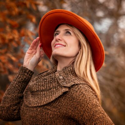 woman in an orange hat with clear skin during autumn